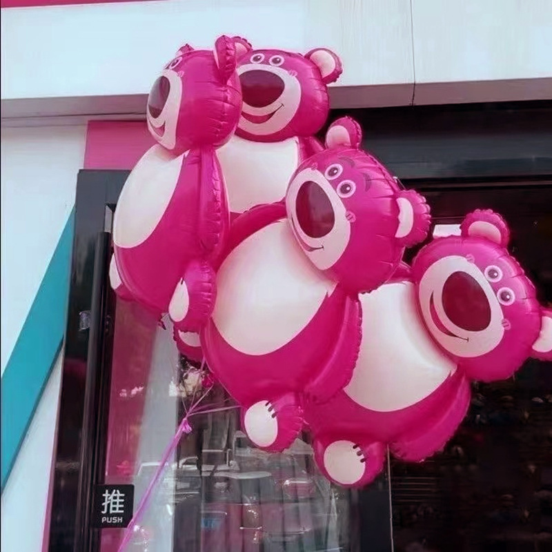 Cartoon strawberry bear shaped aluminum film balloon lotso girl outdoor pose holding props aluminum foil balloon floating in the air