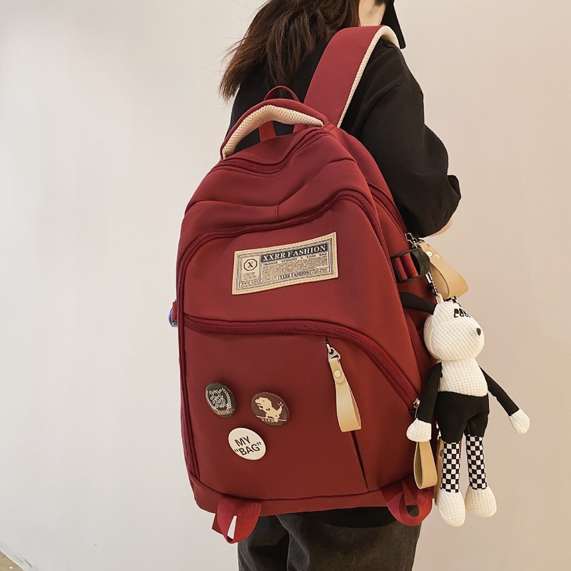 College Style Label Badge Student School Bag Large Capacity Simple Backpack for Junior High School Students Wholesale