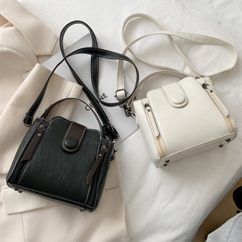 Hong Kong style retro bucket bag women's popular new fashion Korean version fashionable solid color wide shoulder strap single shoulder crossbody bag