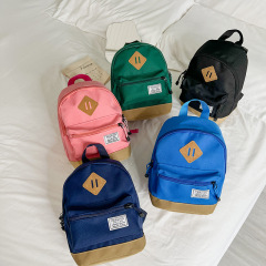 Korean version of boys travel backpack simple lightweight boys and girls canvas solid color small backpack children's bag